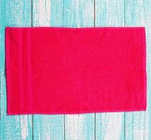 Red soft towel on wooden background mockup copy space photo