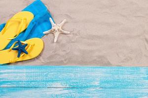 Sand copy space. Sand background top view.Beach towel, beach slippers and starfish photo