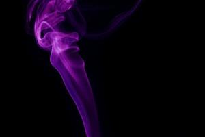 Purple smoke on black background photo