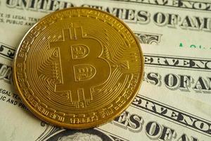 Golden bitcoin on US dollar banknotes money for business and commercial, Digital currency, Virtual cryptocurrency, blockchain technology. photo