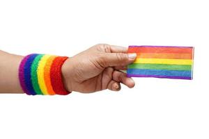 Asian woman holding rainbow flag isolated on white background with clipping path, LGBT symbol rights and gender equality, LGBT Pride Month in June. photo