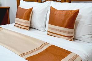 Brown pillows on wooden bed photo