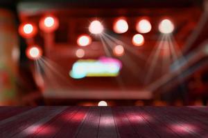 top red desk with blur restaurant background,Wooden table and blurred bokeh of night street background photo