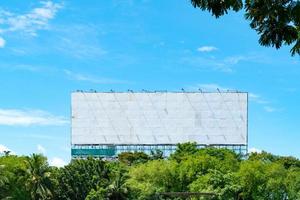 white billboards in forest with blue sky and white clouds photo