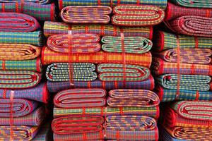 stacked  thai style mats for sale in market photo