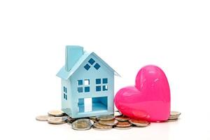 coins stacks and heart-shaped and house on white background,business saving and investment concept photo