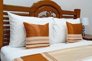 Brown pillows on wooden bed photo