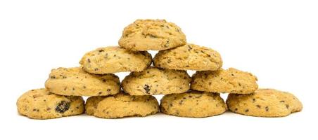 butter cookies with cashew nuts forming pyramid at eye level. isolated on white background photo