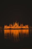 Hungarian parliament building from across the Danube river at night Budapest Hungary photo