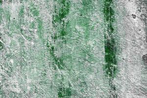 Texture of a concrete wall with cracks and scratches which can be used as a background photo