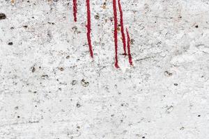 Texture of a concrete wall with cracks and scratches which can be used as a background photo