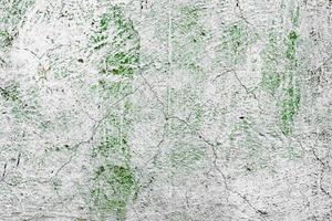 Texture of a concrete wall with cracks and scratches which can be used as a background photo