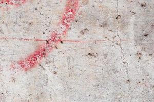 Texture of a concrete wall with cracks and scratches which can be used as a background photo