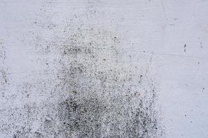 Texture of a concrete wall with cracks and scratches which can be used as a background photo