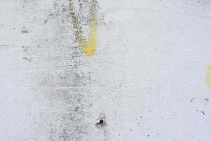 Texture of a concrete wall with cracks and scratches which can be used as a background photo