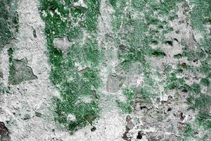 Texture of a concrete wall with cracks and scratches which can be used as a background photo