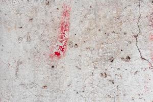 Texture of a concrete wall with cracks and scratches which can be used as a background photo