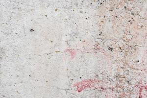 Texture of a concrete wall with cracks and scratches which can be used as a background photo