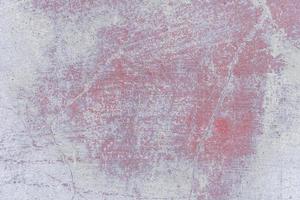 Texture of a concrete wall with cracks and scratches which can be used as a background photo