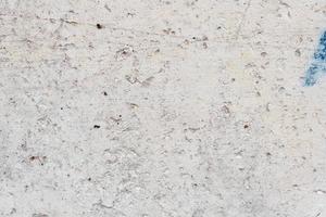Texture of a concrete wall with cracks and scratches which can be used as a background photo