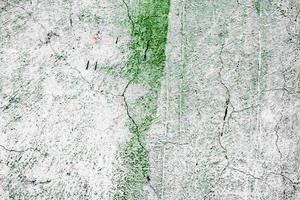 Texture of a concrete wall with cracks and scratches which can be used as a background photo