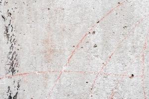 Texture of a concrete wall with cracks and scratches which can be used as a background photo