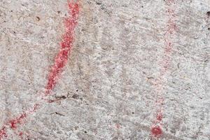 Texture of a concrete wall with cracks and scratches which can be used as a background photo