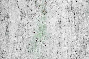 Texture of a concrete wall with cracks and scratches which can be used as a background photo