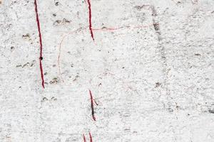 Texture of a concrete wall with cracks and scratches which can be used as a background photo