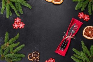 Festive Christmas table with appliances, gingerbreads, tree branches and dried citrus trees photo