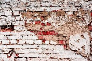 Weathered texture of stained old dark white and orange brick wall background photo