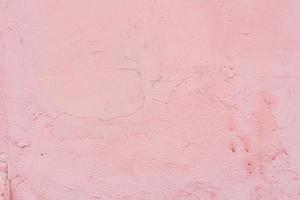 Texture of a concrete wall with cracks and scratches which can be used as a background photo