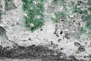 Texture of a concrete wall with cracks and scratches which can be used as a background photo