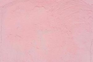Texture of a brick wall with cracks and scratches which can be used as a background photo