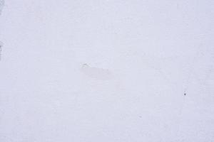 Texture of a concrete wall with cracks and scratches which can be used as a background photo