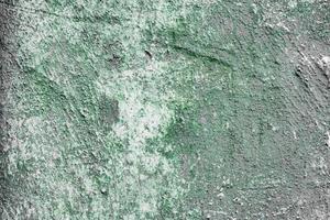 Texture of a concrete wall with cracks and scratches which can be used as a background photo