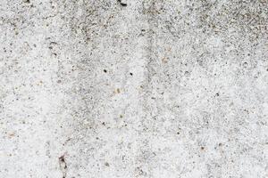 Texture of a concrete wall with cracks and scratches which can be used as a background photo