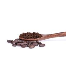 Coffee beans with ground coffee in a spoon on a white background photo