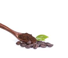 Coffee beans with ground coffee in a spoon on a white background photo