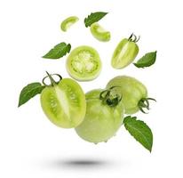 Fresh green tomatoes with leaves on white background photo