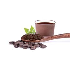 Coffee beans with ground coffee in a spoon on a white background photo