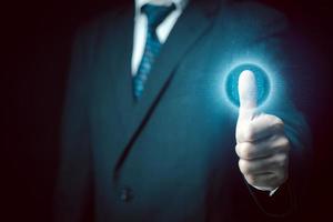 Businessman scans his fingerprint to access personal financial data. Futuristic business technology security concept. Innovation technology against digital cybercrime. Biometrics identity. photo