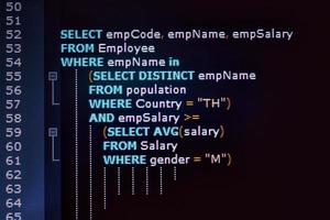 Close up photo from a computer screen SQL or Structured Query Language code . Example of SQL code to query data from a database.