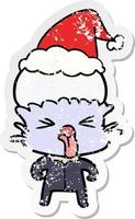 weird distressed sticker cartoon of a alien wearing santa hat vector