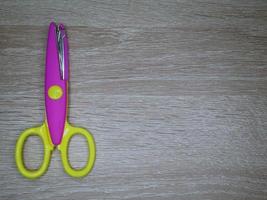 Children's wavy-patterned paper scissors to use in various inventions. photo