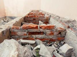 Close-up of the rubble of an industrial building collapsing into a pile of concrete and brick. and the jagged debris caused by the failure of the engineers at the abandoned construction. photo