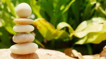 The Balance Stones are stacked as pyramids in a soft natural bokeh background, representing the calm philosophical concept of Jainism's wellness. photo