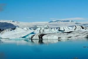 Bright clear blue iceberg floating in the Jokulsarlon lake blue cold water in Iceland 58 photo