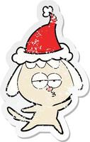 distressed sticker cartoon of a bored dog wearing santa hat vector