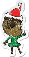 distressed sticker cartoon of a squinting girl wearing santa hat vector